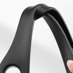 Close-up of a black SeatGuard gap filler strip being bent by hand